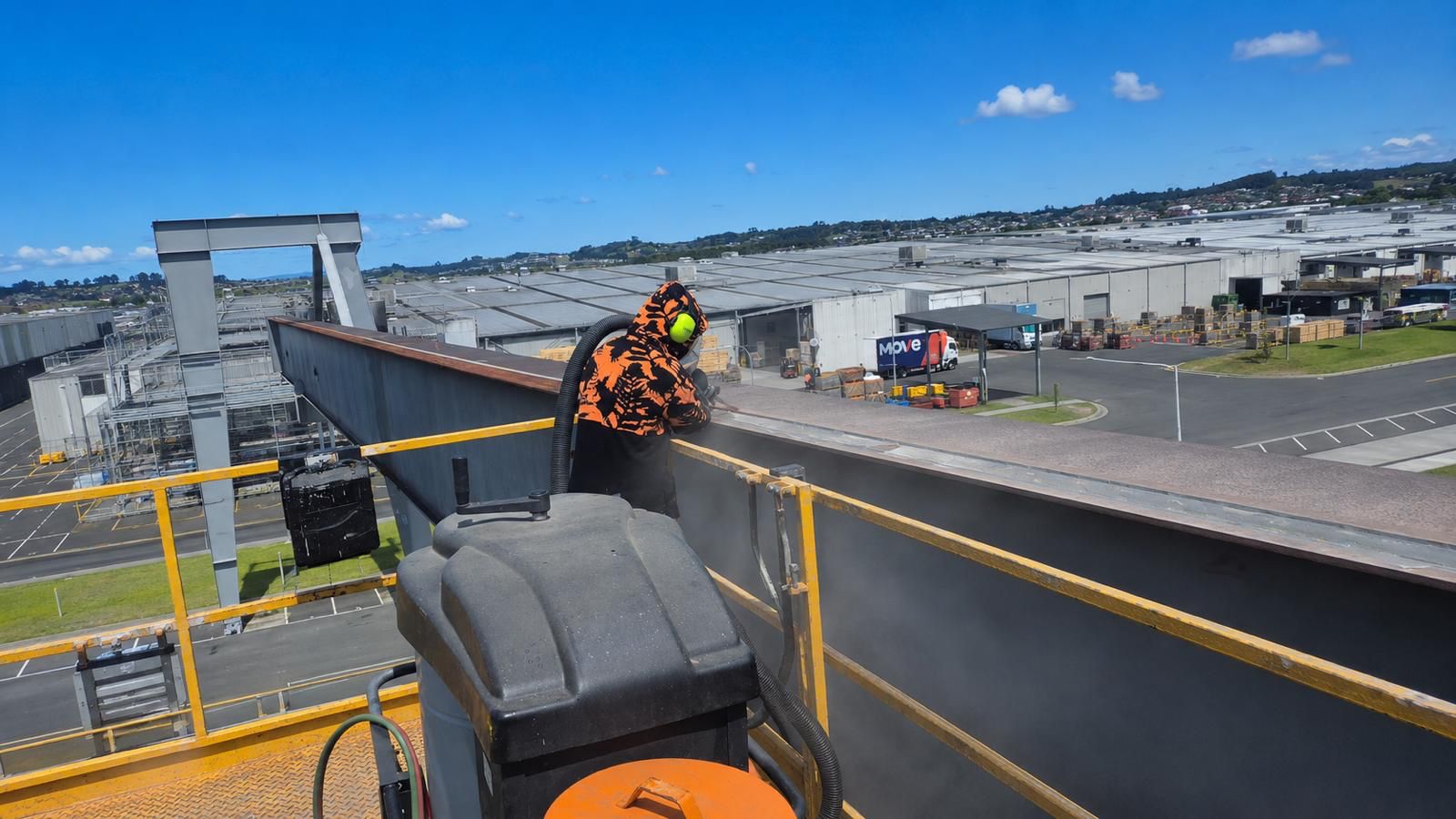 BlastOff operator preparing structural steel at height